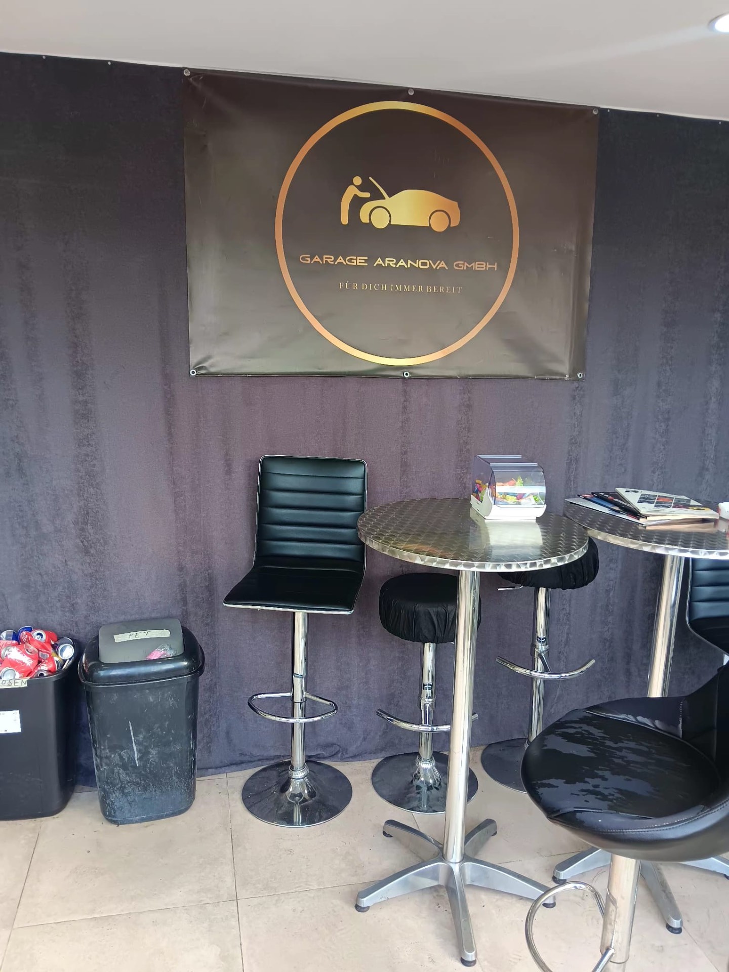 Wartelounge mit Stehtischen und Logo